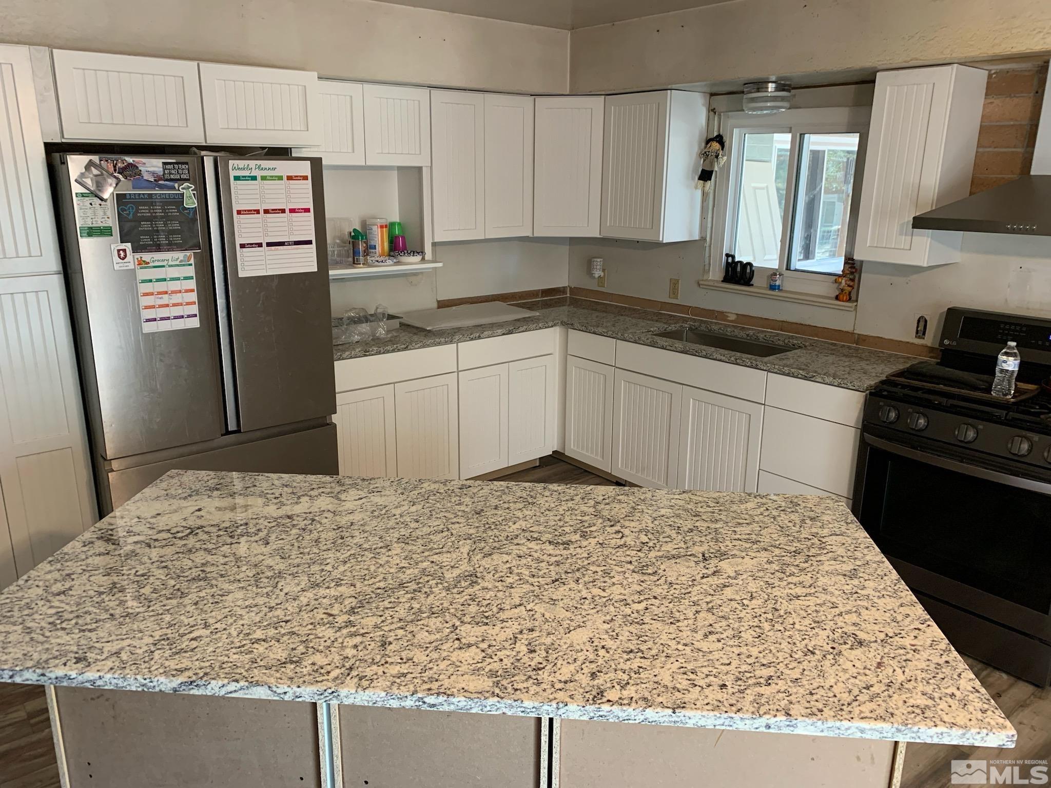 2975 Lone Tree Road Fallon, NV 89406 - Photo 6 of 26 a kitchen with a refrigerator stove and sink