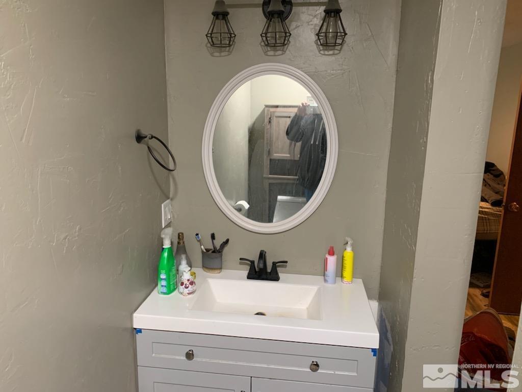2975 Lone Tree Road Fallon, NV 89406 - Photo 9 of 26 a bathroom with a sink and a mirror