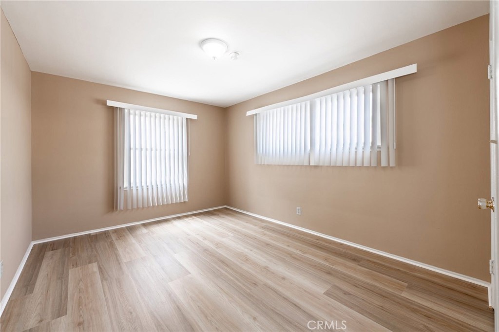 5319 Whitsett Avenue, Unit 3 Valley Village, CA 91607 - Photo 7 of 11 an empty room with wooden floor and windows