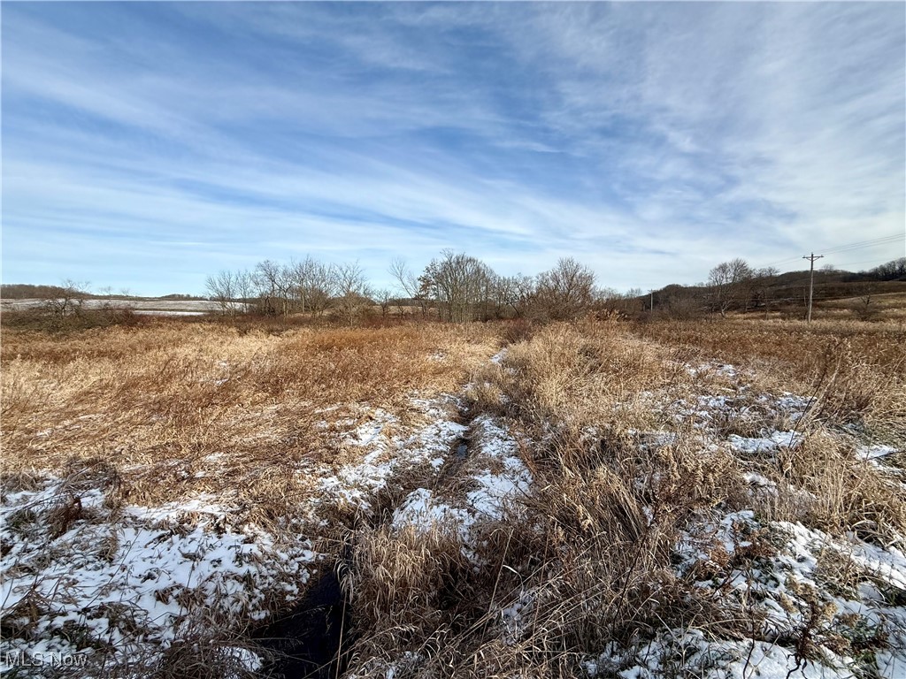 Snowy landscape featuring a view of countryside
