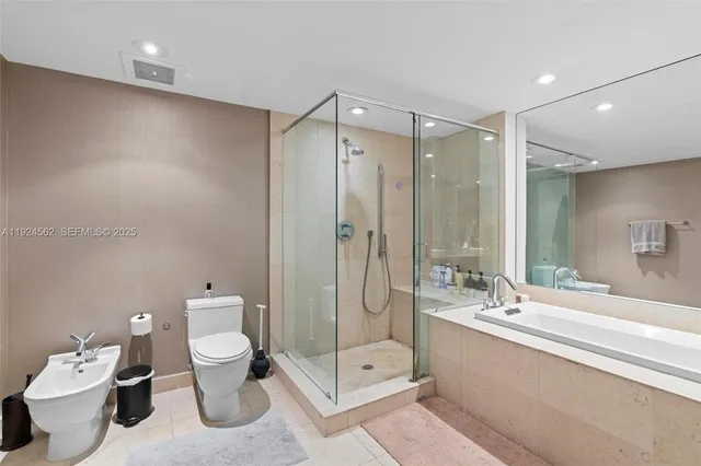 a bathroom with a double vanity sink toilet and shower