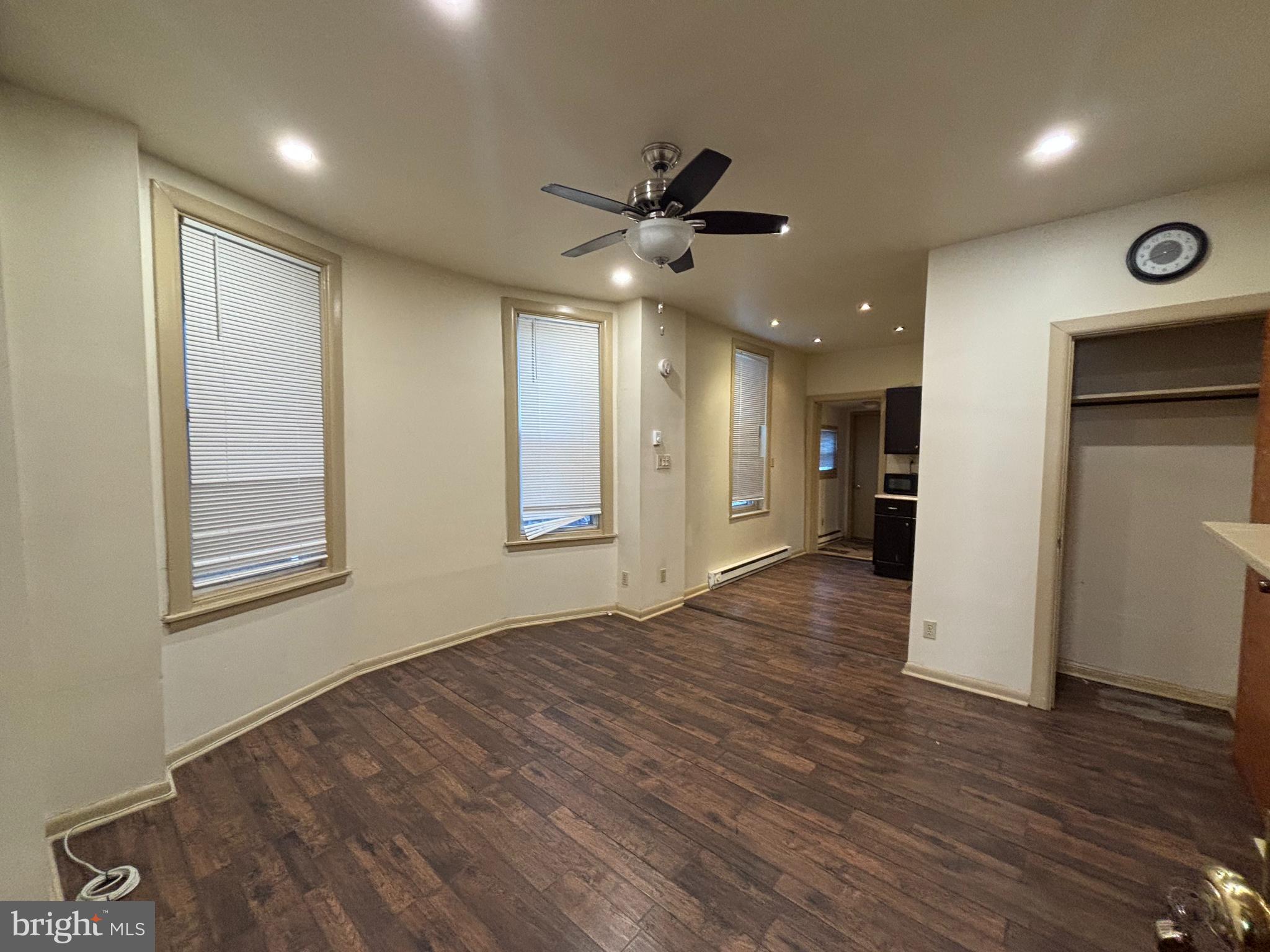 3734 North Sydenham Street, Unit 1 Philadelphia, PA 19140 - Photo 2 of 6 a view of an empty room with wooden floor and a window