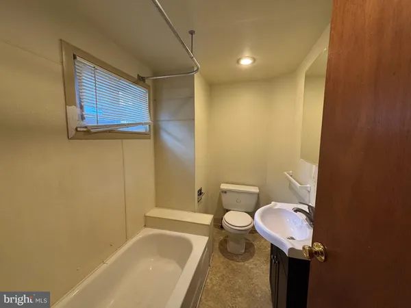 a bathroom with a sink toilet and bathtub