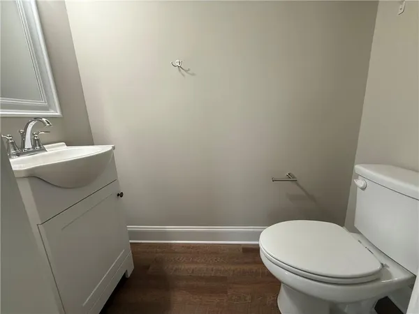 a white toilet sitting next to a bathroom sink