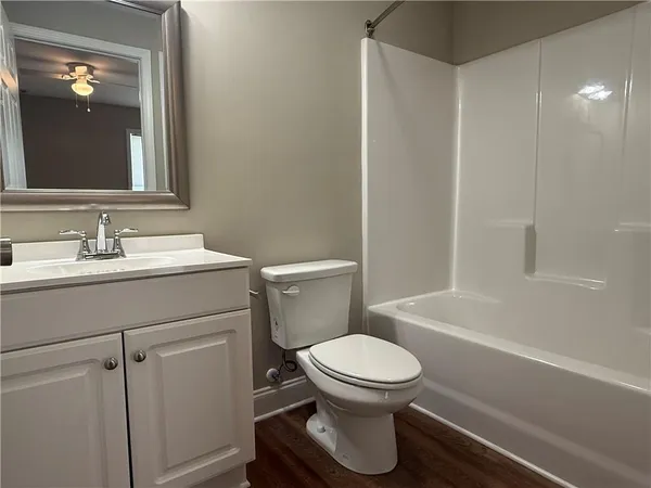 a bathroom with a toilet a sink and bathtub