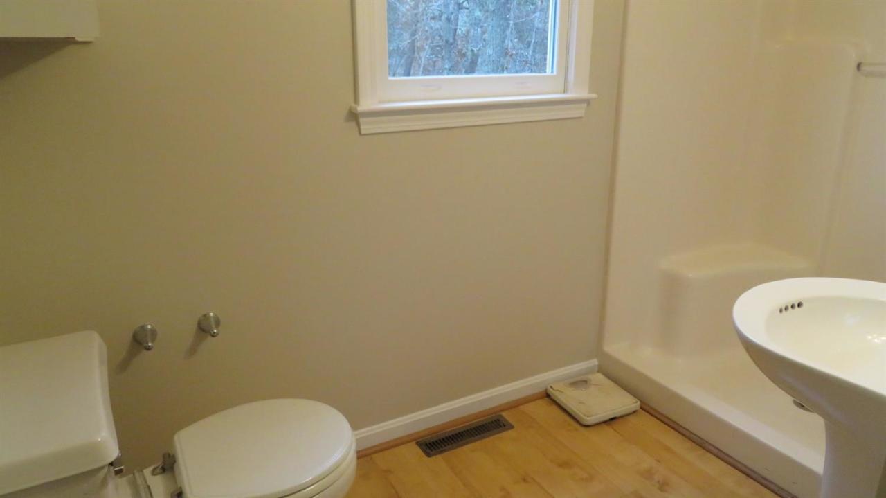 285 Shootflying Hill Road Centerville, MA 02632 - Photo 15 of 25 a bathroom with a granite countertop toilet and a sink