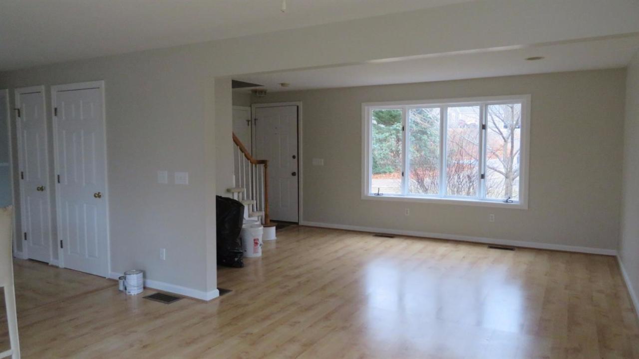 285 Shootflying Hill Road Centerville, MA 02632 - Photo 6 of 25 a view of an empty room with wooden floor and a window