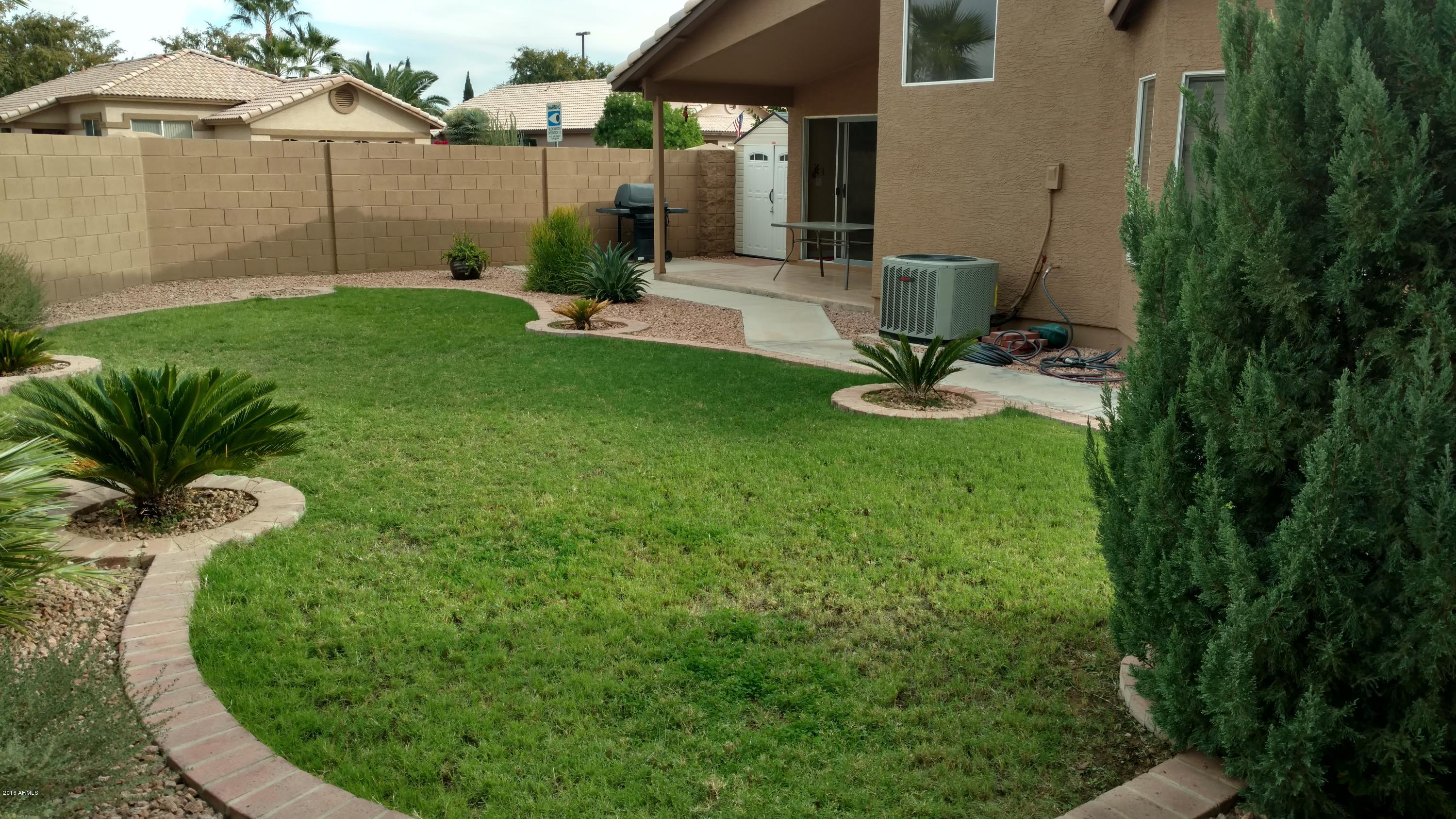 44 West Del Rio Street Gilbert, AZ 85233 - Photo 15 of 21 a view of a backyard with table and chairs potted plants