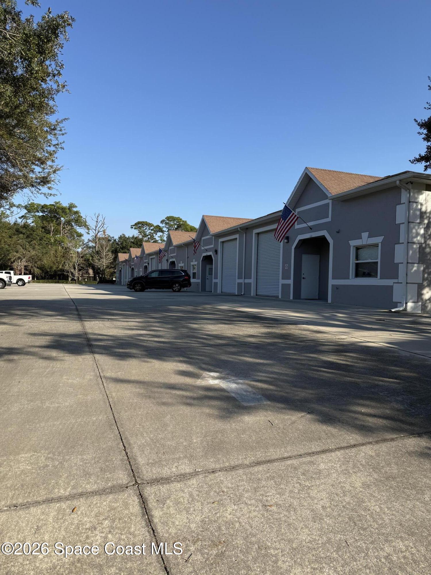 624 Atlantis Road, Unit 103 Melbourne, FL 32904 - Photo 3 of 14 a view of a house with a street