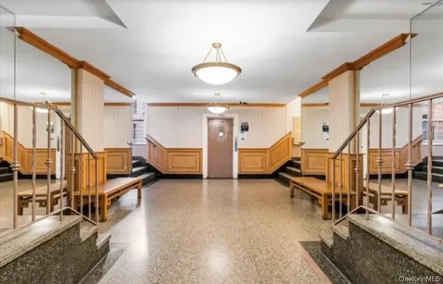 a view of a room with lots of white furniture and stairs