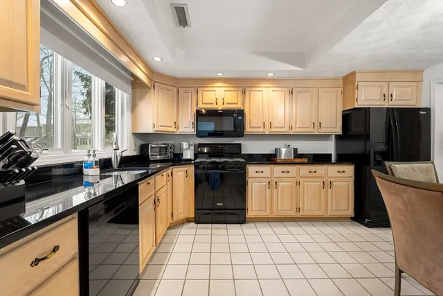a kitchen with a sink cabinets and appliances