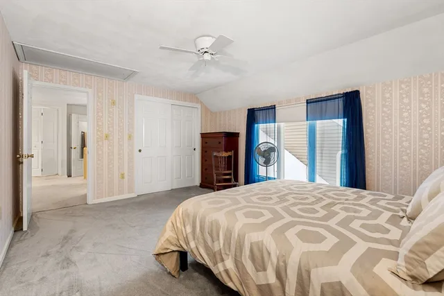 a spacious bedroom with a bed and a chandelier