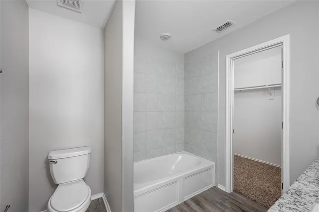 a bathroom with a toilet and a bathtub