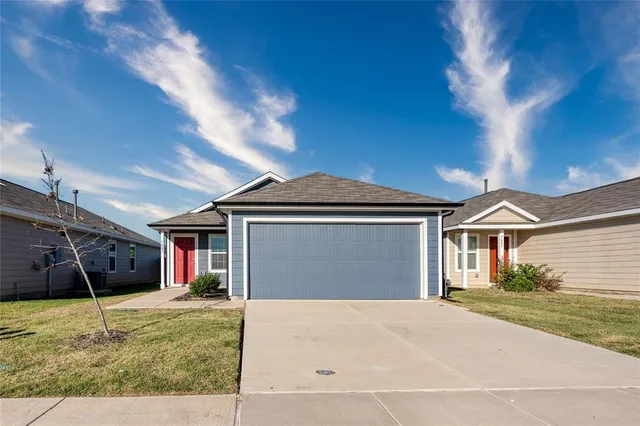 a view of a yard in front of a house with garage