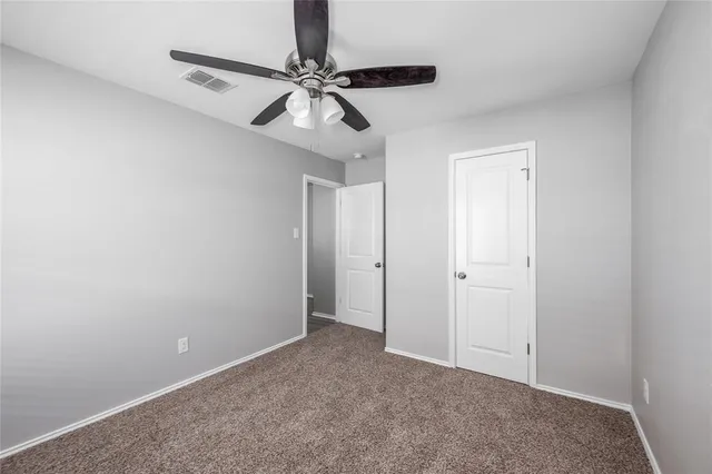 a view of a room with a ceiling fan