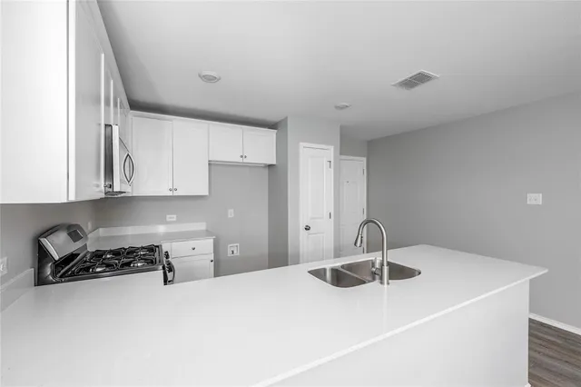 a kitchen with a sink and cabinets