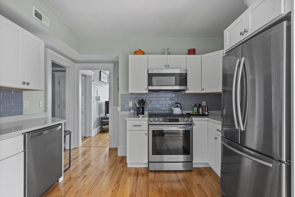 40 King Street, Unit 3 Boston, MA 02122 - Photo 3 of 14 a kitchen with stainless steel appliances a refrigerator sink and microwave