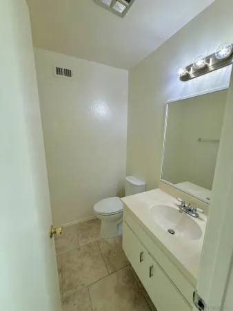a bathroom with a sink a toilet and mirror