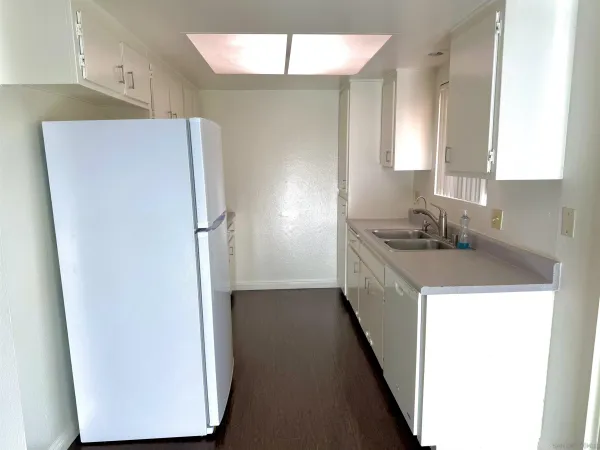 a kitchen with a refrigerator a sink and dishwasher
