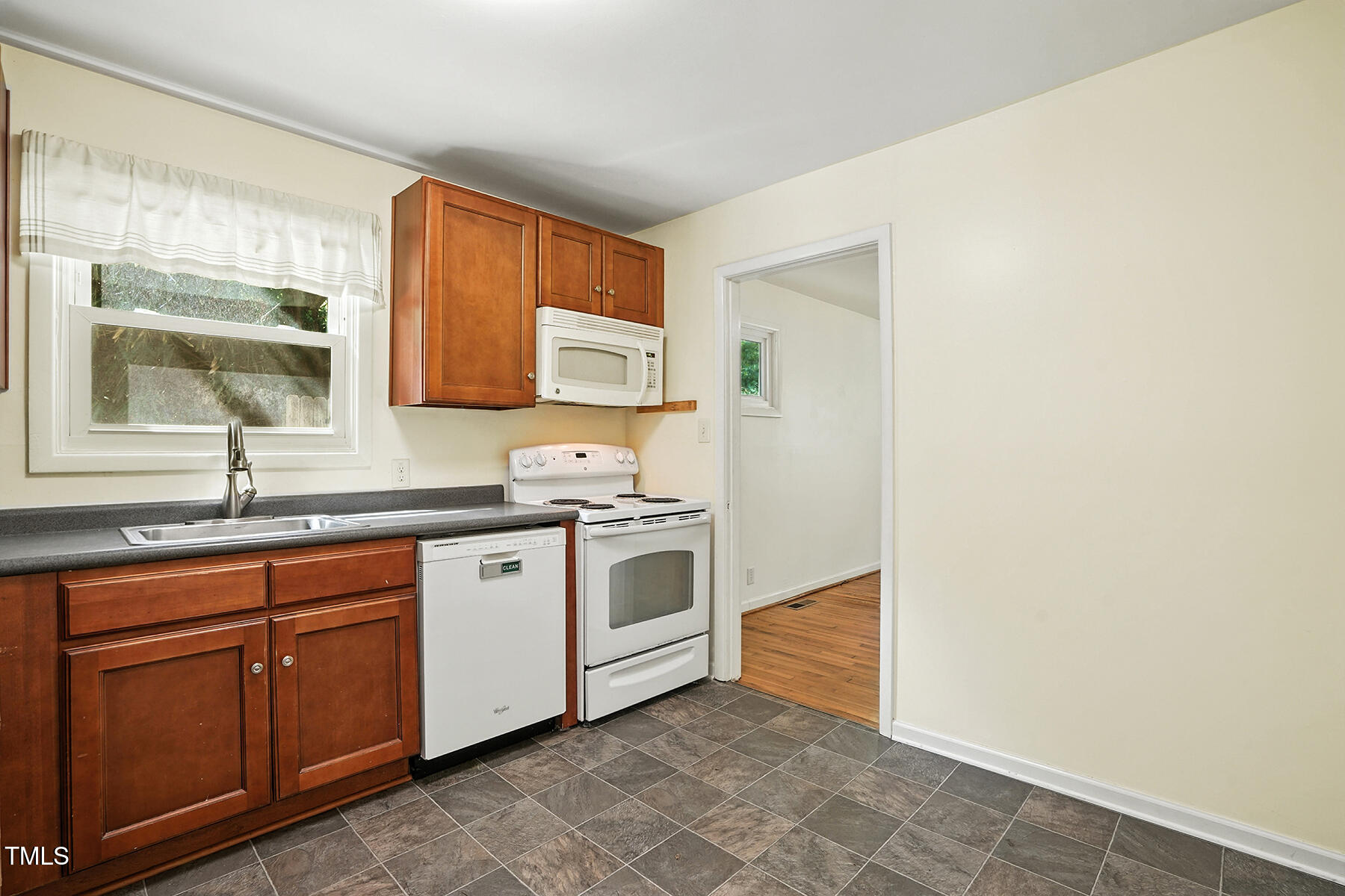 912 Dixie Trail Raleigh, NC 27607 - Photo 11 of 27 a kitchen with a sink cabinets and window