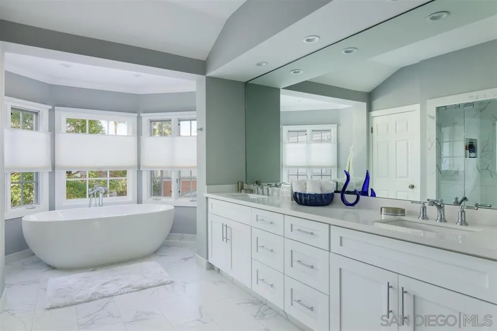 9 Buccaneer Way Coronado, CA 92118 - Photo 16 of 23 a bathroom with a granite countertop double vanity sink a mirror and bathtub