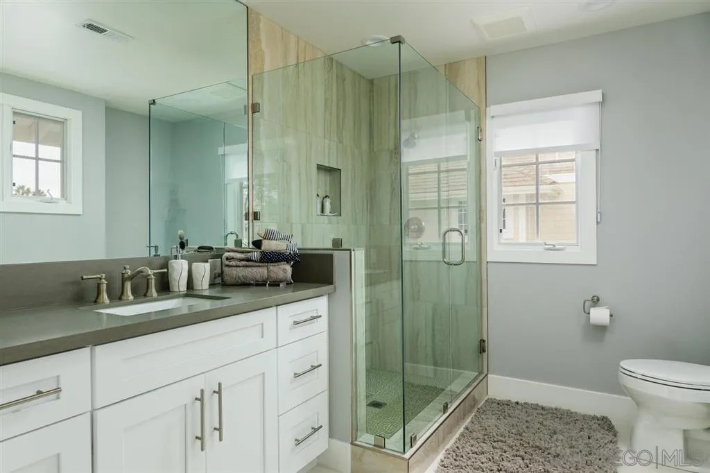 9 Buccaneer Way Coronado, CA 92118 - Photo 18 of 23 a bathroom with double vanity sink toilet and shower