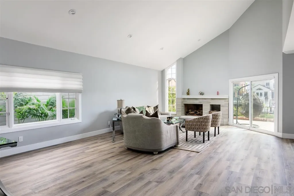 9 Buccaneer Way Coronado, CA 92118 - Photo 5 of 23 a living room with furniture a fireplace and a table