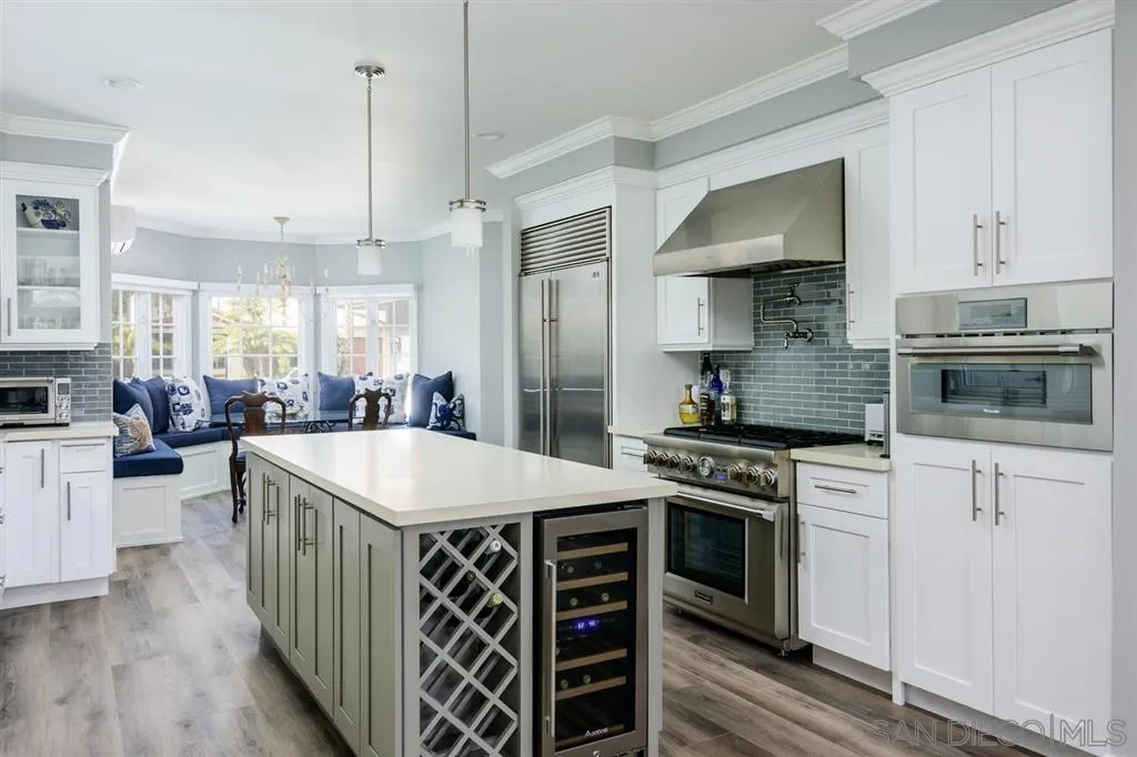 9 Buccaneer Way Coronado, CA 92118 - Photo 10 of 23 a kitchen with stainless steel appliances a stove top oven a sink dishwasher a refrigerator white cabinets and wooden floor