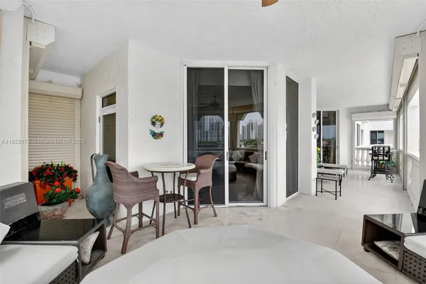 a view of walk in closet with white cabinets