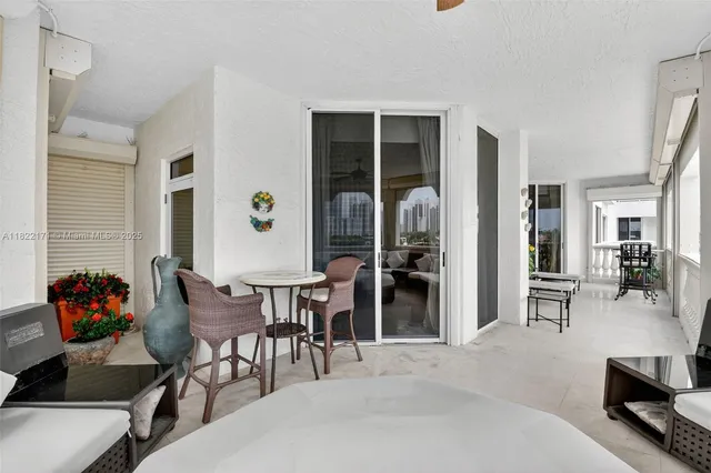 a view of walk in closet with white cabinets