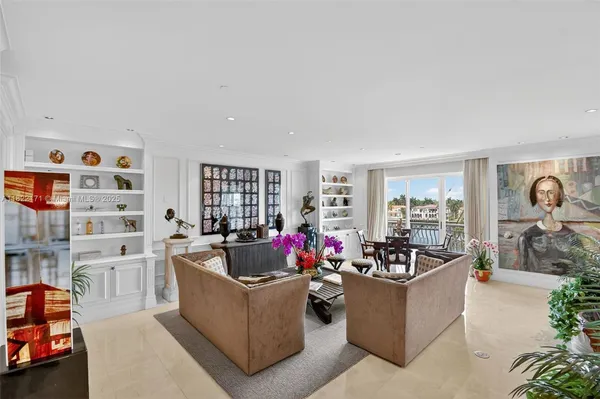 a living room with furniture and flowers