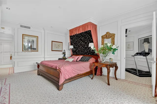 a dining table with a large window and chandelier