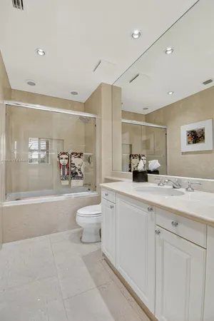 a view of a dining room with furniture a chandelier and large windows