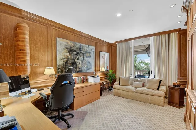 a view of a dining room with furniture a chandelier and a large window