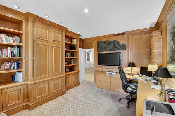 a dining room with furniture a chandelier and outdoor view