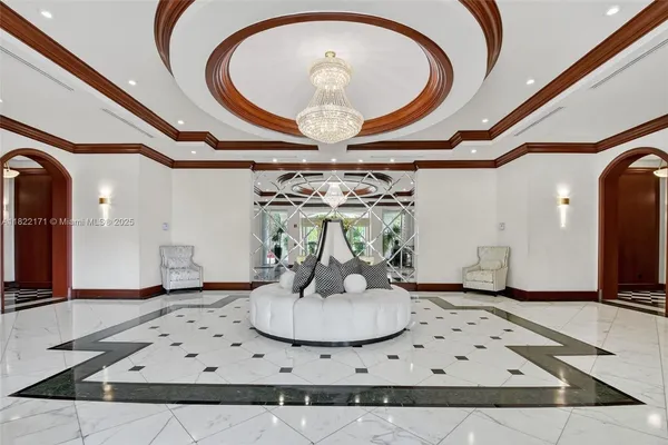a living room with stainless steel appliances kitchen island granite countertop a stove and a white cabinets