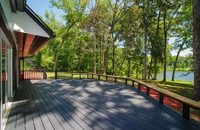 a view of a wooden deck with a yard