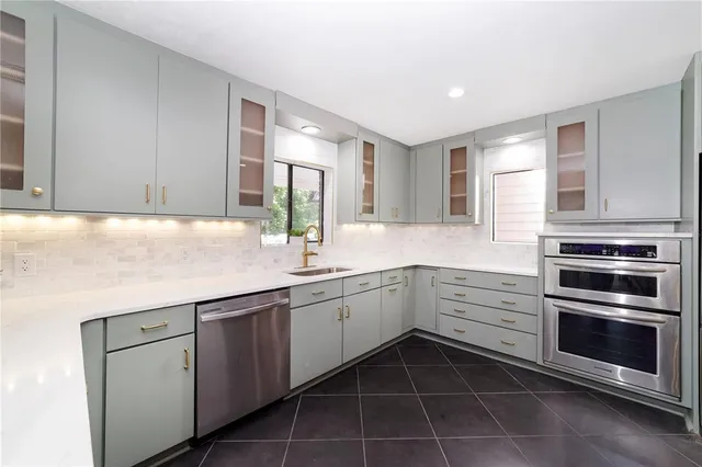 a kitchen with a sink and cabinets
