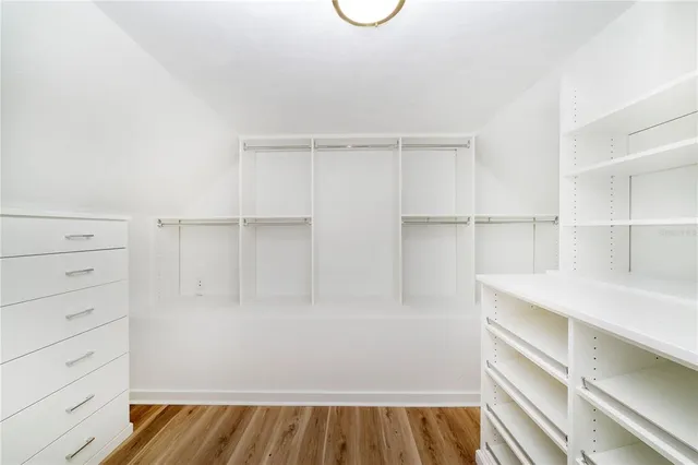 a view of walk in closet with empty racks