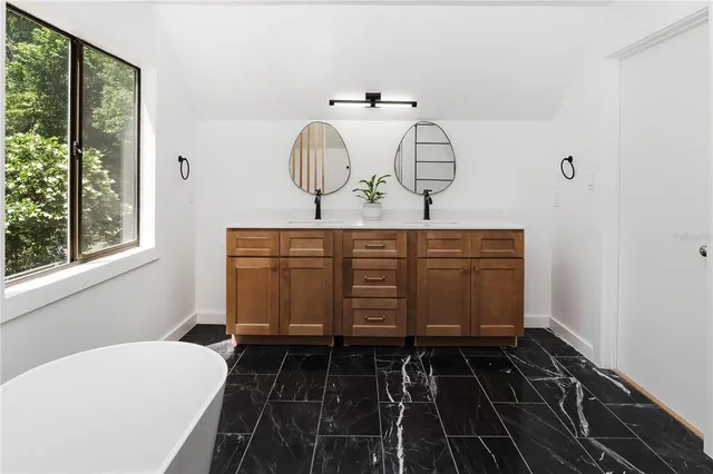 a white tub sitting next to a window