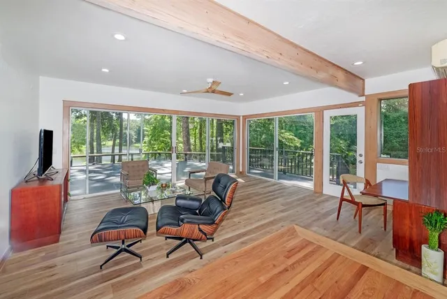 a living room with furniture and floor to ceiling window