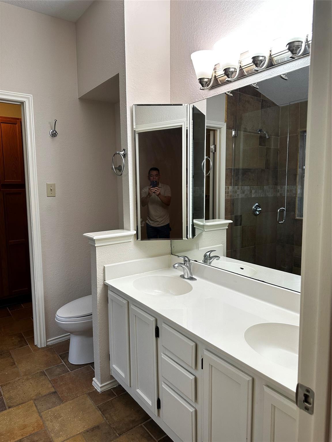 8007 Bounty Trail Austin, TX 78749 - Photo 21 of 32 Double vanities and tiled flooring complement this refreshed primary bathroom.
