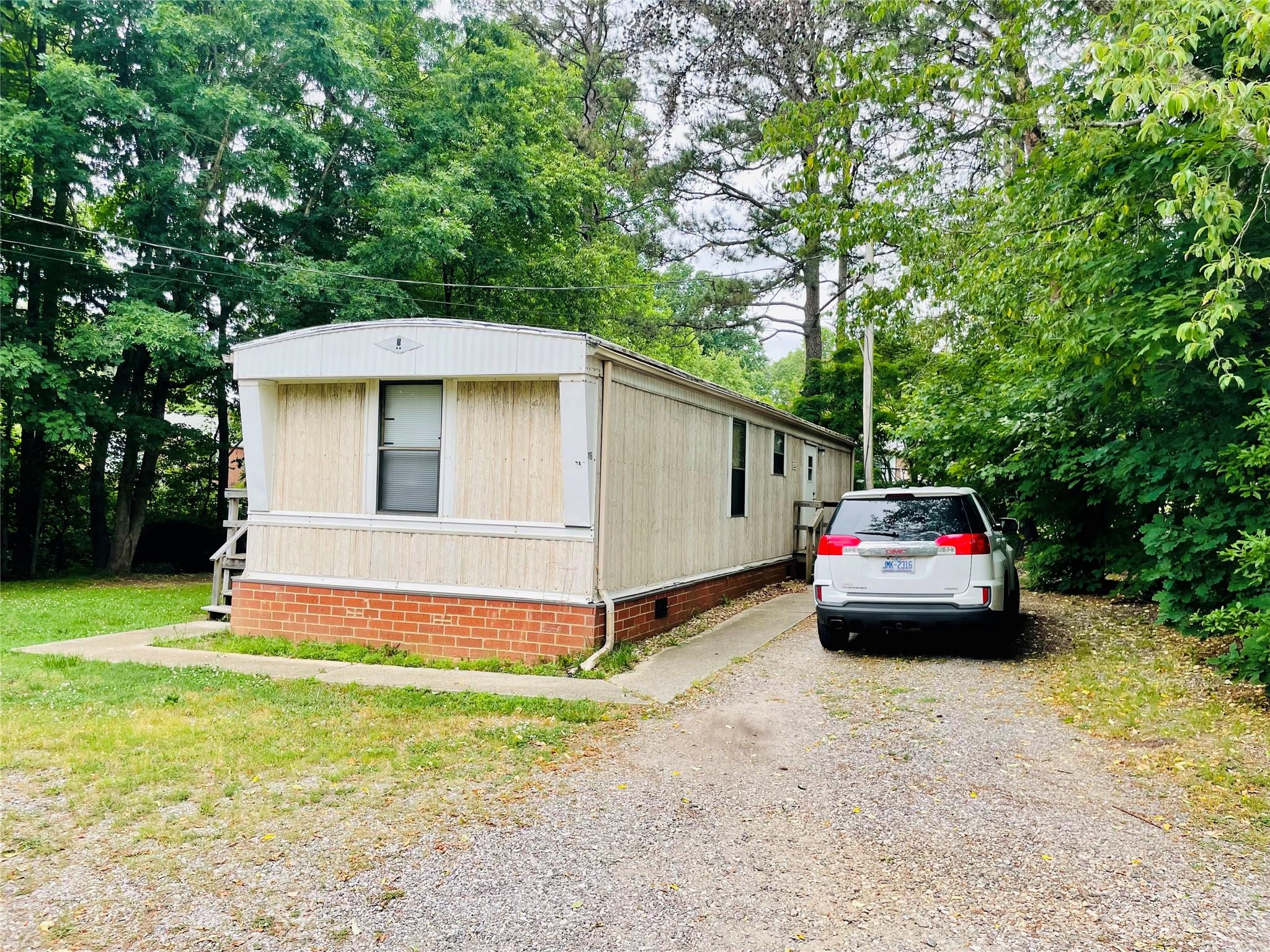 161 Longbranch Road Statesville, NC 28677 - Photo 4 of 7 a white house covered with tall trees