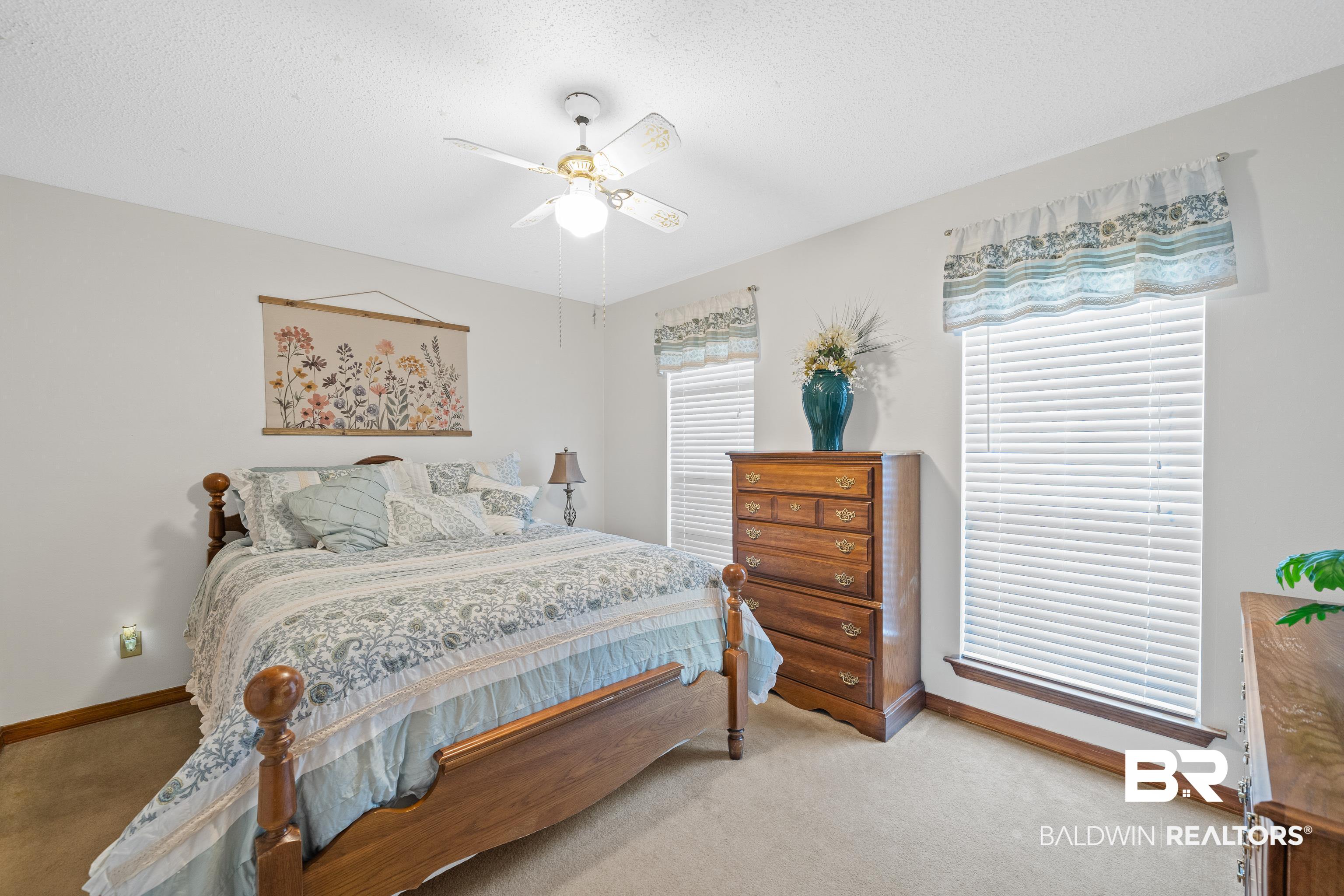 460 Ridgewood Drive Daphne, AL 36526 - Photo 8 of 31 Carpeted bedroom featuring a textured ceiling and ceiling fan