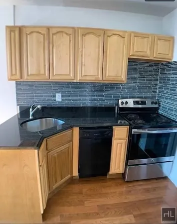 a kitchen with granite countertop a stove and a microwave