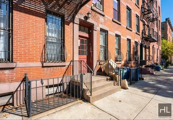 a view of a brick house with many windows