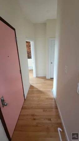 a view of a hallway with wooden floor