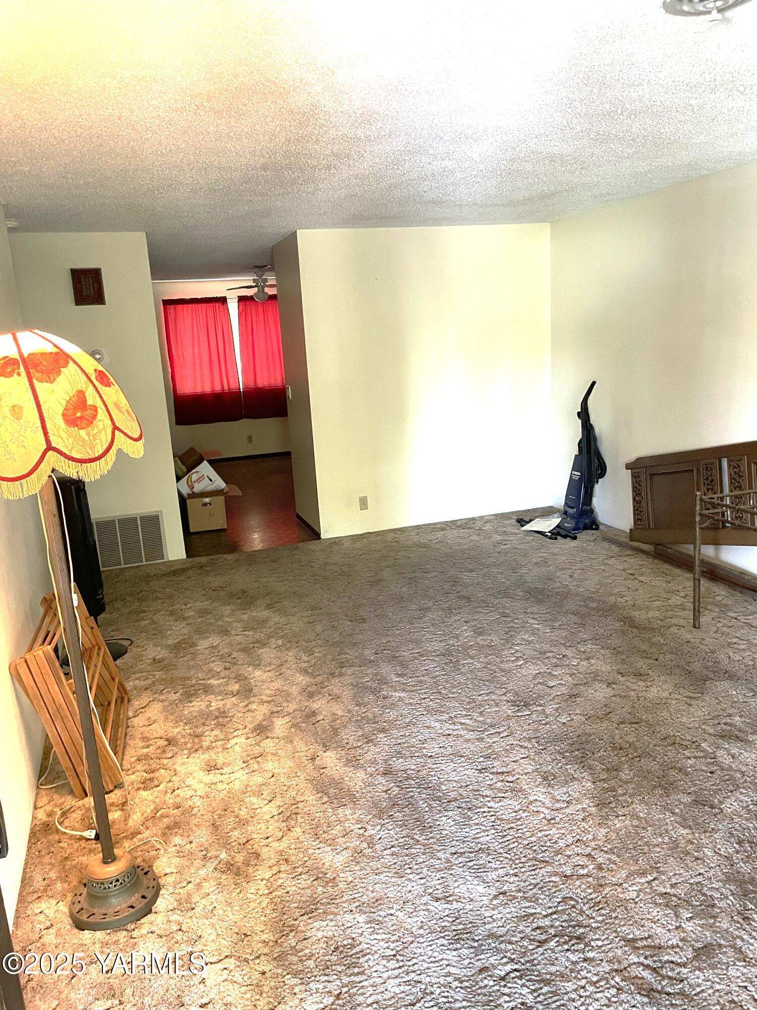 703 South 38th Avenue, Unit 8 Yakima, WA 98902 - Photo 5 of 10 a view of an empty room and floor to ceiling window