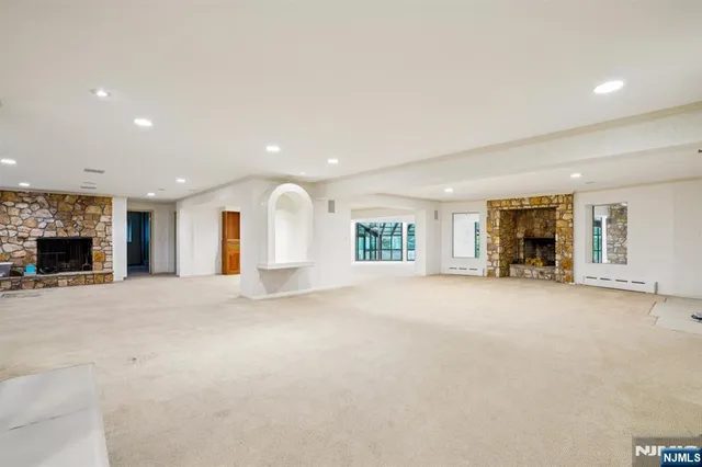 a view of a livingroom with fireplace and window