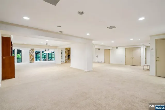 a view of an empty room with closet and window